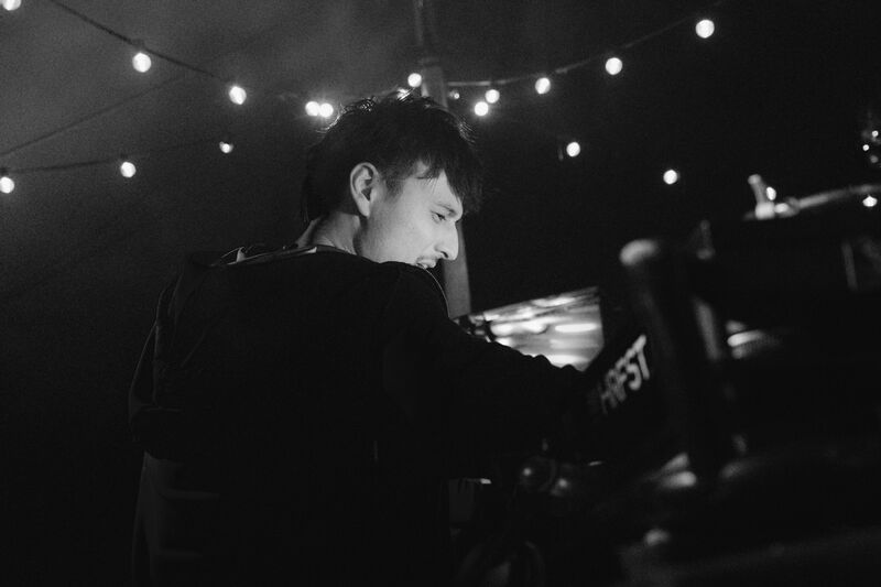 Robin focused at the decks with string lights at HRFST
